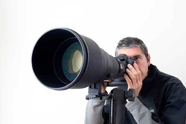 Long telephoto lens Photographer with long telephoto lens sports photography stock pictures, royalty-free photos & images