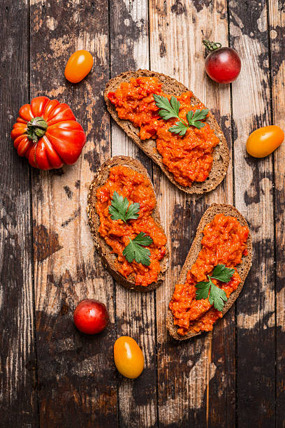 istock Bread with tomato spread on rustic wooden background, top view. 486593754