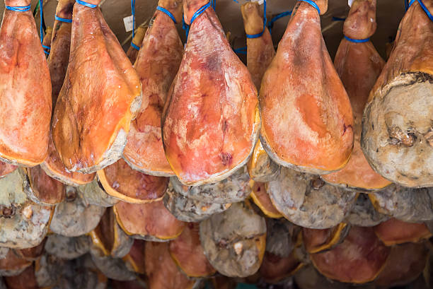 muchos bayona jamones cuelgan del techo - butchers shop meat market pork fotografías e imágenes de stock