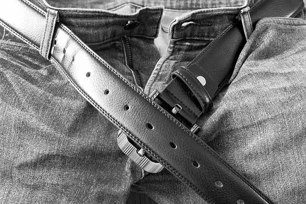 Photo of Leather belt on  jeans pants background