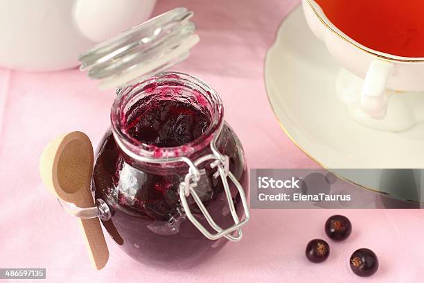 Black Currant Jam In Glass Jar With Tea Stock Photo - Download Image Now - Black Currant, Gelatin Dessert, Jar
