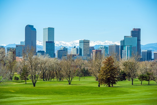 Sunny Denver Skyline. Spring in Colorado. Denver Skyline and Snowy Rocky Mountains.