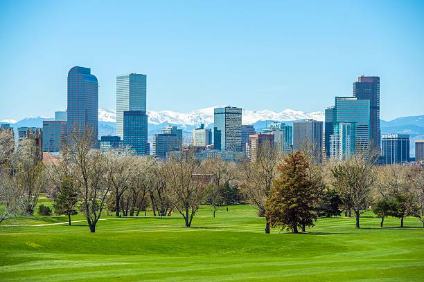 Sunny Denver Skyline Sunny Denver Skyline. Spring in Colorado. Denver Skyline and Snowy Rocky Mountains. denver stock pictures, royalty-free photos & images