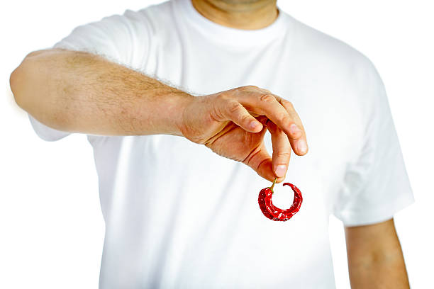 Man holding red hot chili pepper