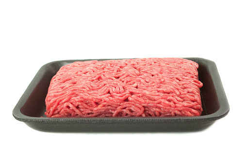 A tray of fresh lean ground beef from supermarket isolated on white background