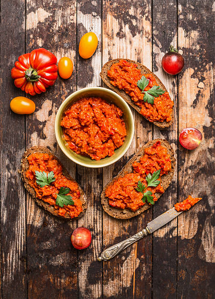 istock Vegetarian snack with tomatoes spread on bread , top view. 486600044