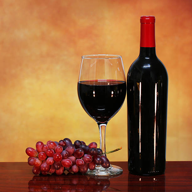 istock Wine Bottle and Glass of Red Wine with Grapes 486601475