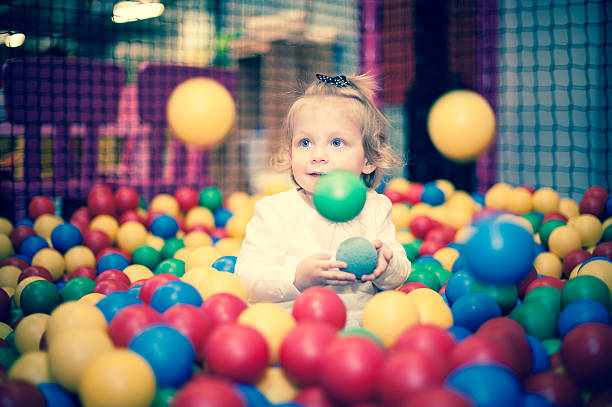 istock Baby girl in ball pool 486601991