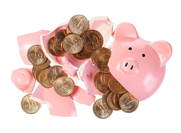 istock Broken Piggy Bank with Gold Coins isolated 486602281