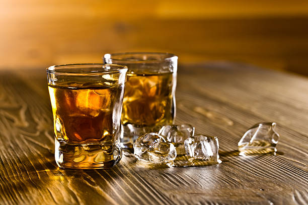 istock whiskey on old wooden table 486602538