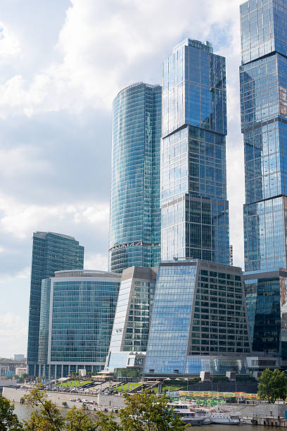 istock High-rise buildings on blue sky and trees 486603782