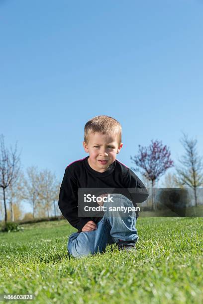 Sad Angry Naugthy Boy Looking At Camera In The Park Stock Photo - Download Image Now