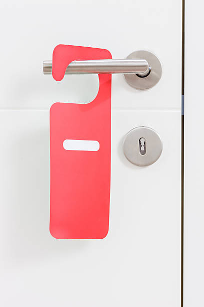 istock Handle of door with do not disturb label on it 486605524