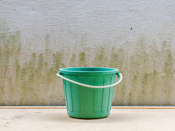 istock water bucket on wall background and wooden 486605572