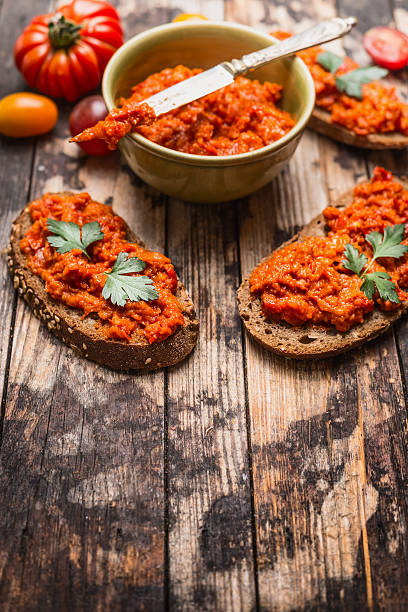 istock Sandwich with tomatoes paprika spread on rustic wooden background. 486605584