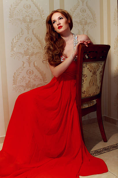 istock girl in a long red dress 486606088