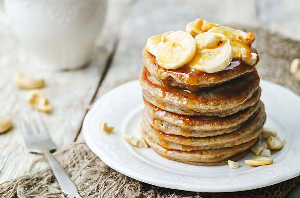 banana cashew pancakes with bananas and salted caramel sauce banana cashew pancakes with bananas and salted caramel sauce. the toning. selective focus pancake photos stock pictures, royalty-free photos & images
