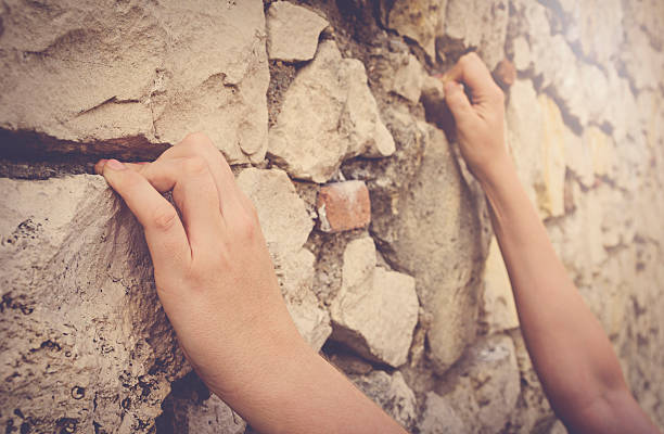 istock Man climbing on rocky wall, hand detail. 486608102