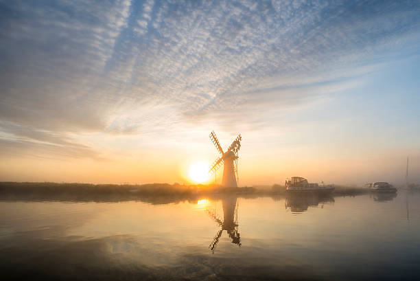 istock Stunnnig landscape of windmill and river at dawn 486609052