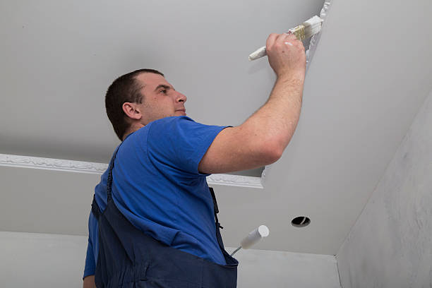istock Renovation of house interior. Man worker painting. 486609220
