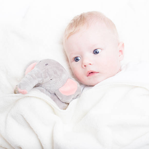 istock Baby with plush toy. 486609276