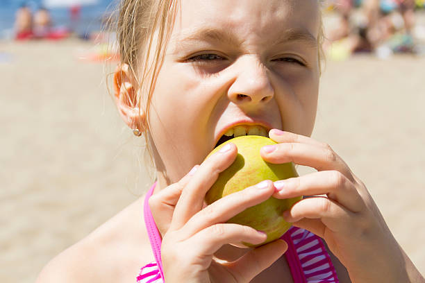 istock Cute girl biting an apple 486609886