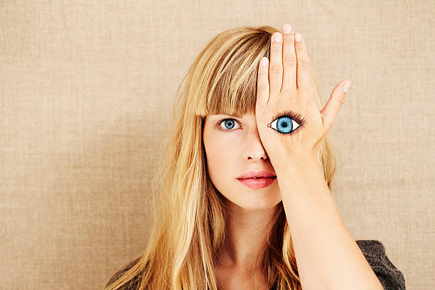 schönes blondes mit bemalten eye - hands covering eyes stock-fotos und bilder