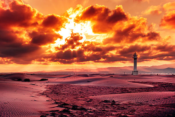 a view of the lighthouse at El Fangar, in the Ebro Delta, in Spain, in a cloudy day