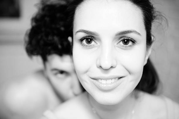 istock man and woman looking into  camera. Black  white picture. 486614418