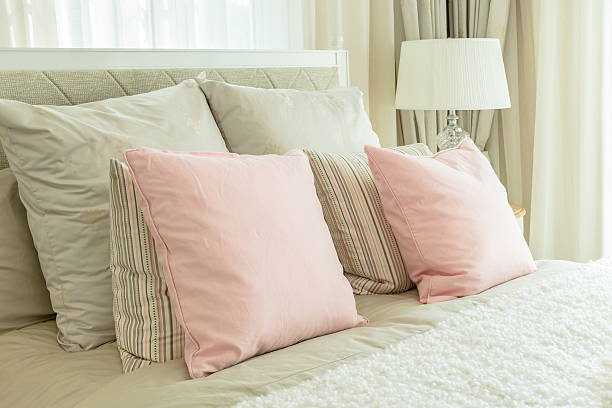 istock cozy bedroom interior with pink pillows and reading lamp 486614854