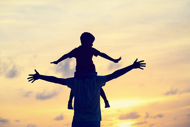 istock father and son on sunset beach 486615370