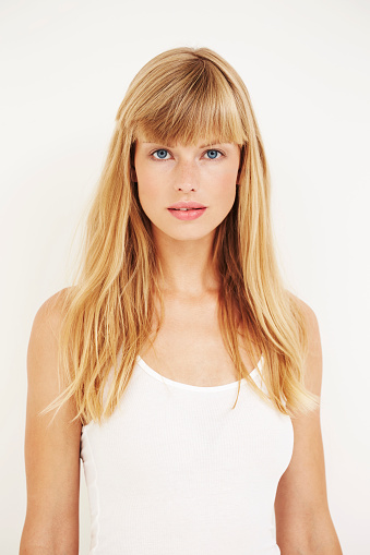 Portrait of beautiful young woman in white, studio