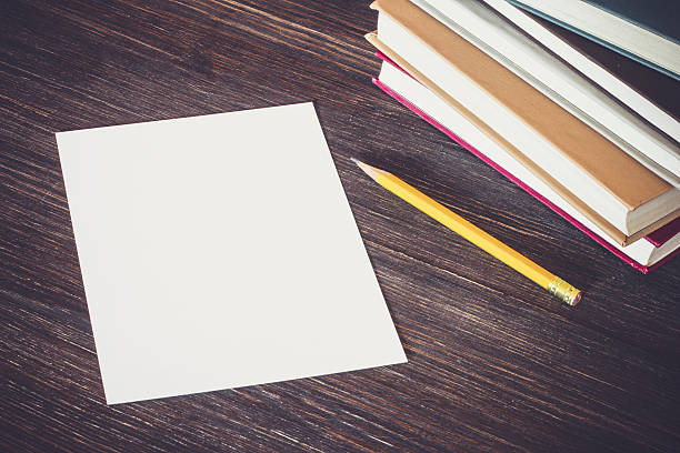istock White Card And Books On Wooden Desk. 486620736