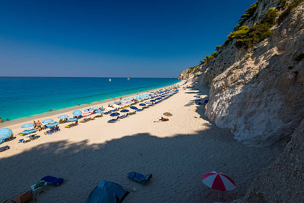 Beautiful clear sea at Egremni beach in Lefkada blue water, green water, lefkada island, greece, ionian sea, beach, holidays, lefkas, levkas, summer, clear sky, blue sky, tourists, rocks, travel, sandy beach, sand, famous, egremni, egremnoi, ship, cruiser, view, amazing egremni beach lefkada island greece stock pictures, royalty-free photos & images