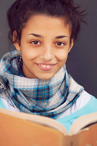 istock Beautiful indian girl smiling with book 486622804