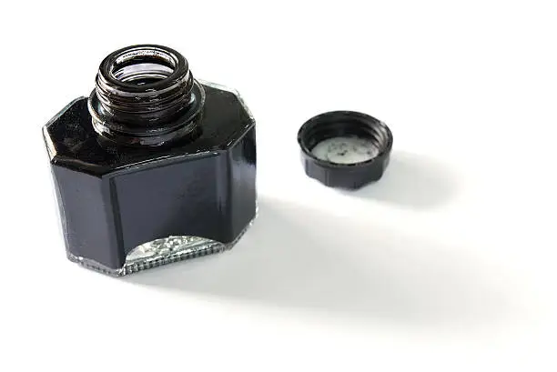 Close-up of black ink in opened bottle.