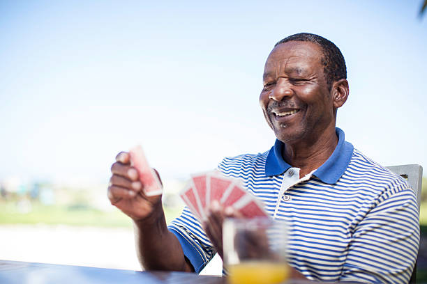 istock African senior playing a game of cards 486624319