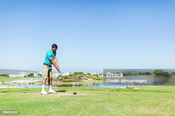 African Golfer Looking At The Ball Ready To Hit It Stock Photo - Download Image Now