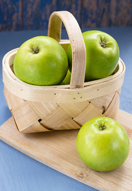 Green Apples in a Wooden Basket stock photo