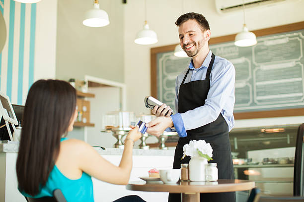 istock Paying with credit card in a cafe 486626128