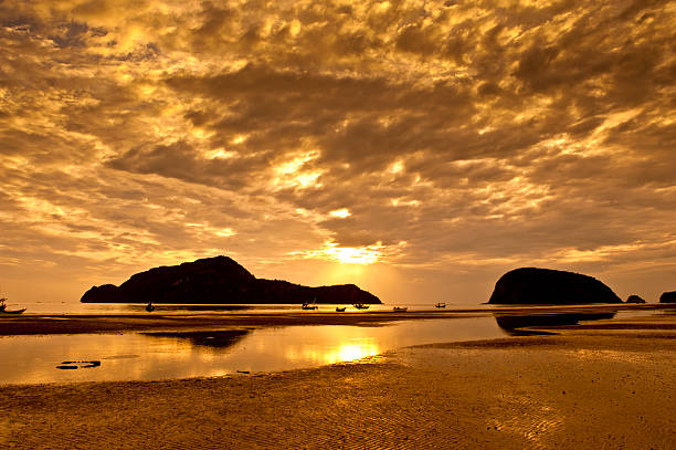 Boats in sunset after the mountain stock photo