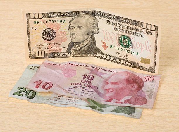 istock Finnacial crisis: new ten dollars over thirty crumpled turkish liras 486630356