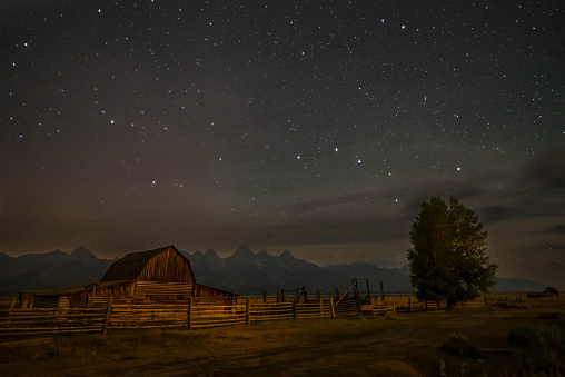 Star filled sky over old and famous Mormon Row Barn in Grand Teton National Park, Wyoming, USA. 