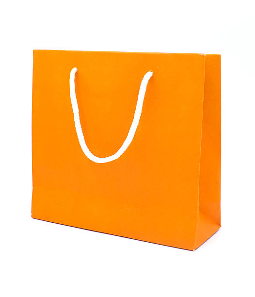 istock Orange paper bag isolated on white background. 486632268