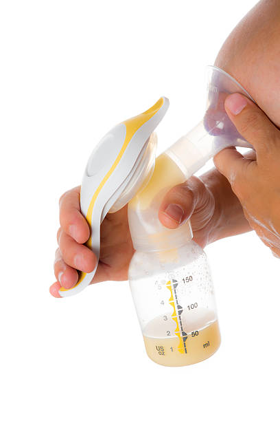 Mother getting milk with a breast pump stock photo