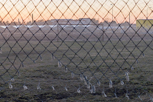 istock Abandoned soccer field through old goal net 486633628