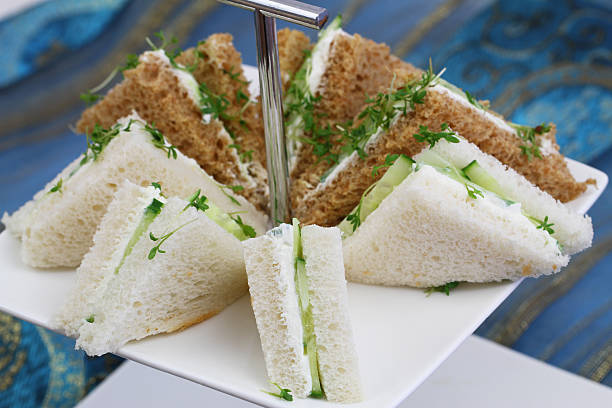 istock White and brown cream cheese and cucumber sandwiches 486636342