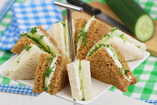 istock White and brown cream cheese and cucumber sandwiches 486636834