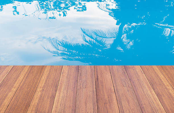 бассейном, а на деревянной террасе фоне - палуба стоковые фото и изображения