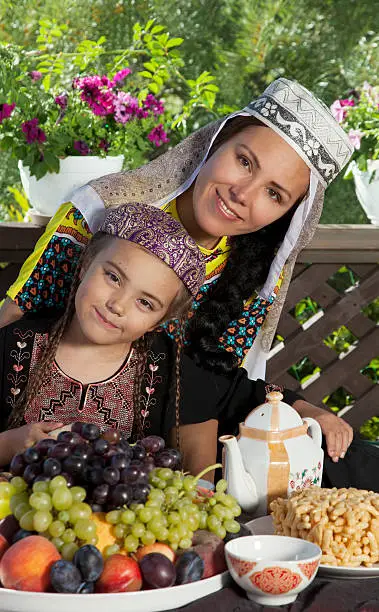 Mother with her daughter have breakfast at Uzbekistan chaikhana.